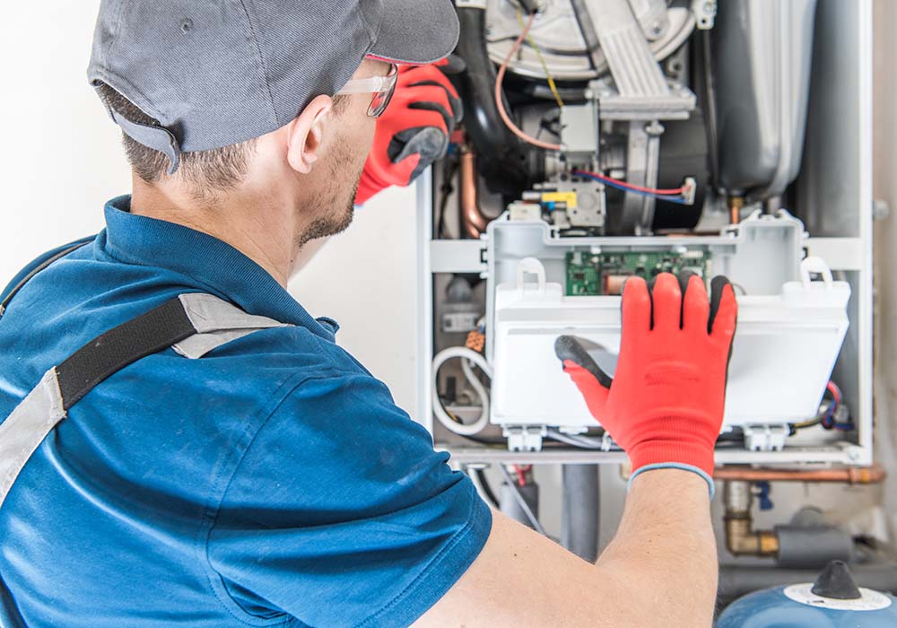 Heating Central Gas Furnace Issue. Technician Trying To Fix the Problem with the Residential Heating Equipment.